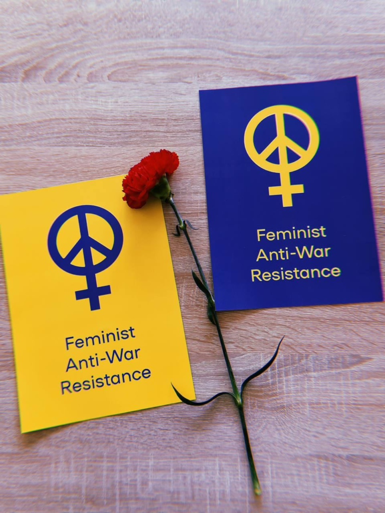 Leaflets of "Feminist Anti-War Resistance" with a red carnation
